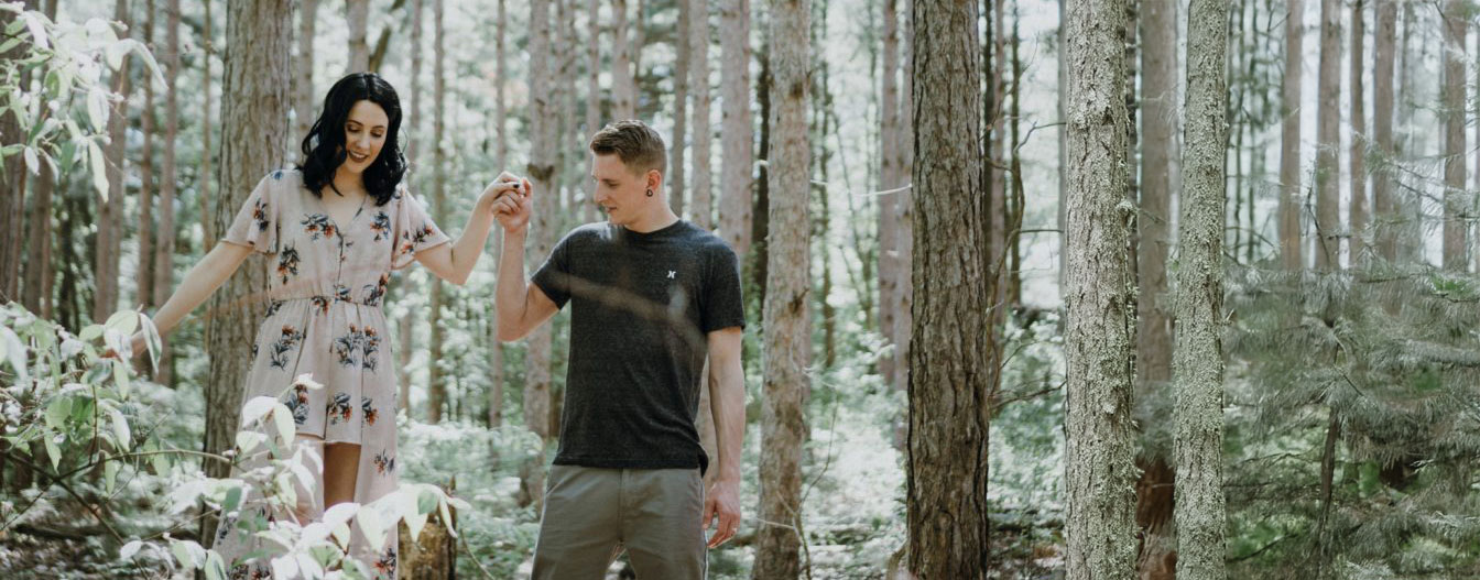 St. Patricks Day Couple holding hands in a snow frosted green forest