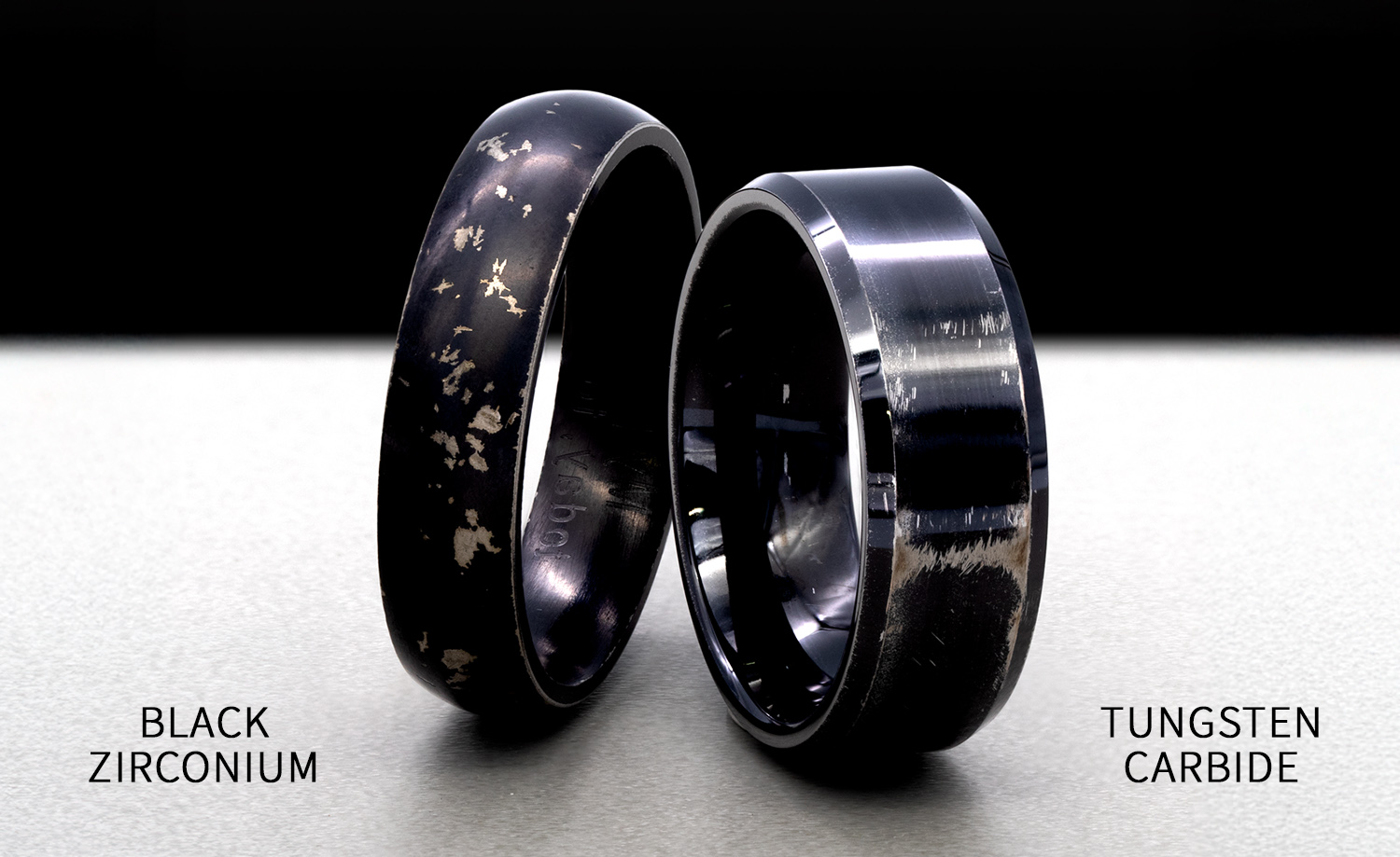 image of black zirconium and black plated tungsten carbide rings, both are worn and black color surface is fading