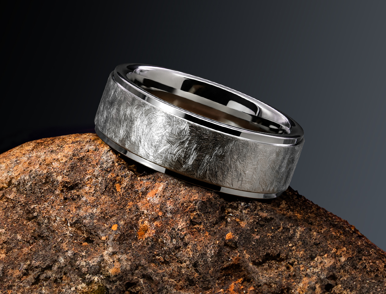men's rugged tungsten ring on rock